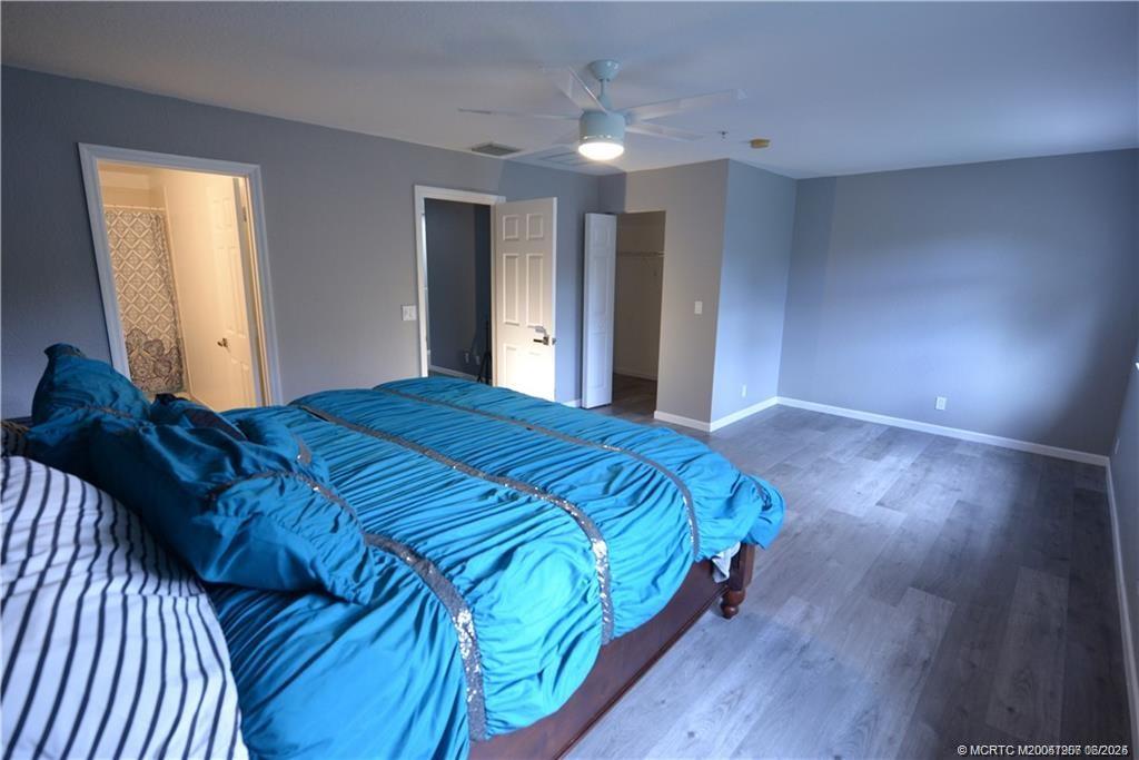 324 Southeast Bloxham Way Stuart, FL 34997 - Photo 28 of 35 a bed sitting in a spacious bedroom next to a window