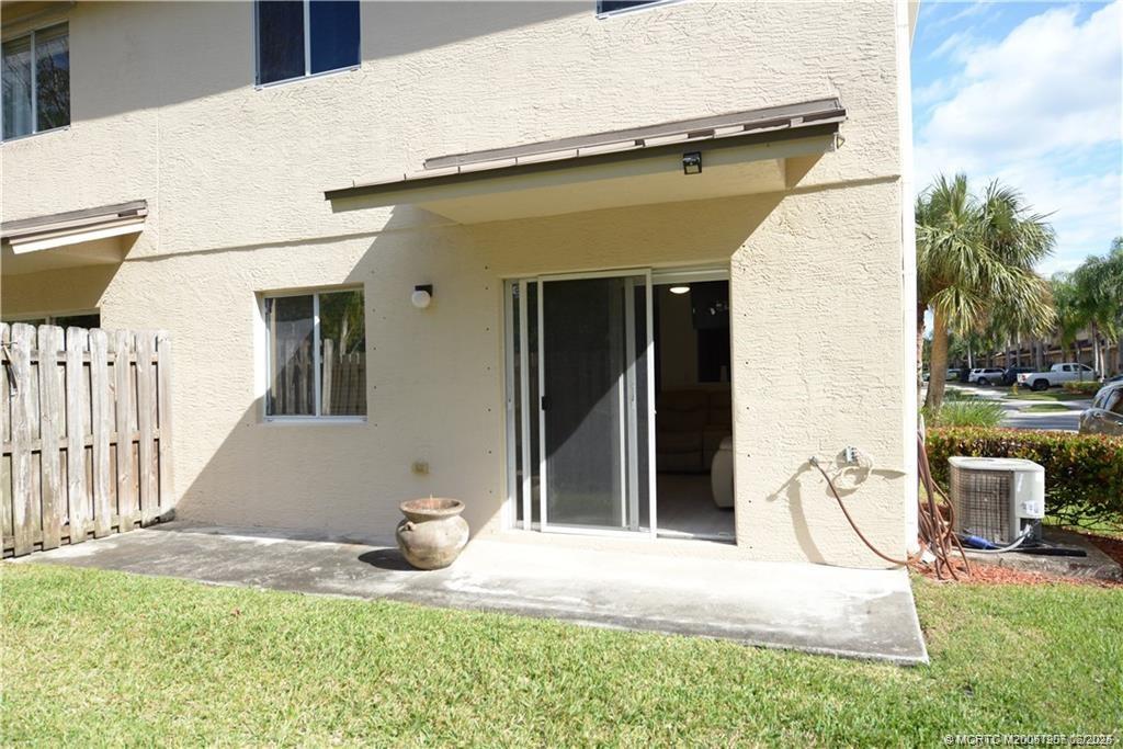 324 Southeast Bloxham Way Stuart, FL 34997 - Photo 3 of 35 a view of a chair and table in backyard of the house