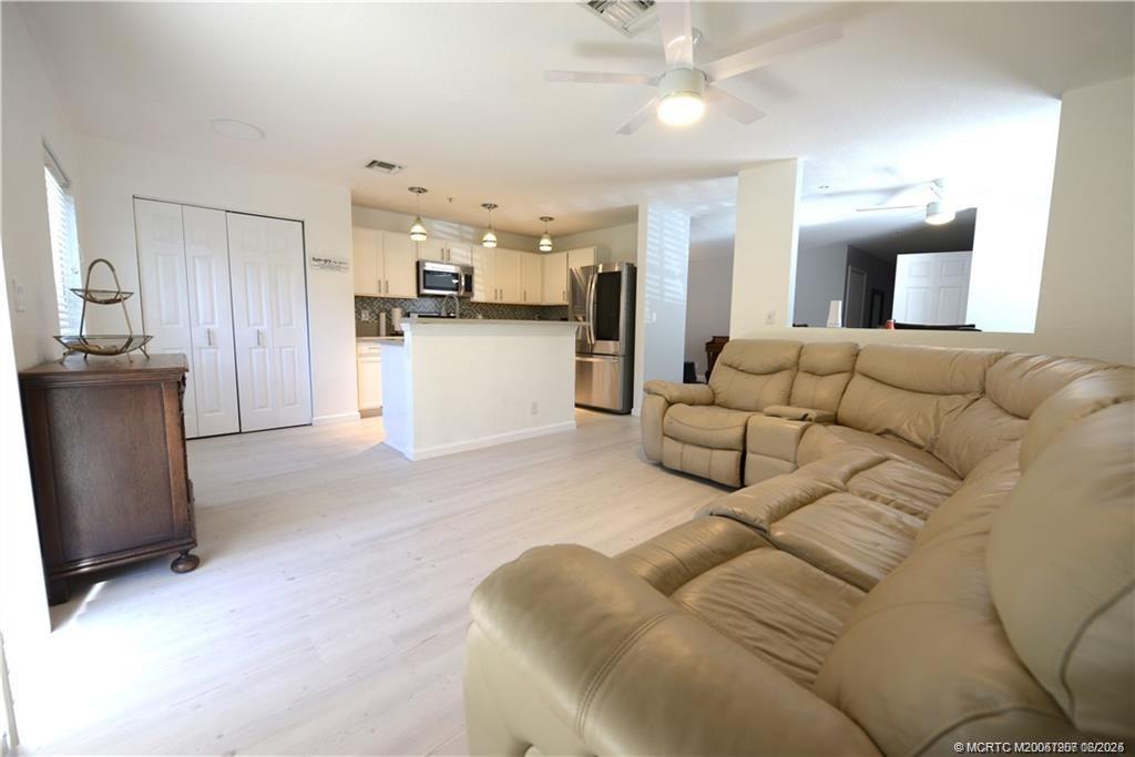 324 Southeast Bloxham Way Stuart, FL 34997 - Photo 31 of 35 a living room with furniture and kitchen view