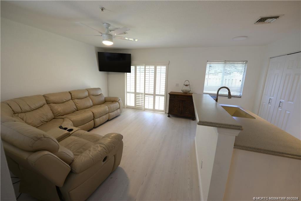 324 Southeast Bloxham Way Stuart, FL 34997 - Photo 32 of 35 a living room with furniture and a flat screen tv