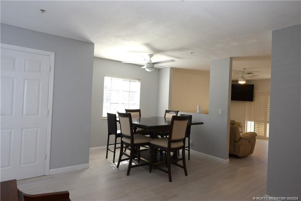 324 Southeast Bloxham Way Stuart, FL 34997 - Photo 33 of 35 a view of a dining room with furniture and chandelier