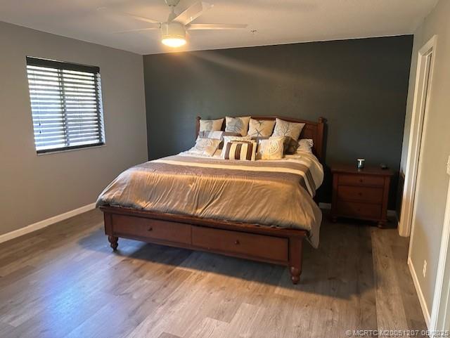 324 Southeast Bloxham Way Stuart, FL 34997 - Photo 6 of 35 a bed sitting in a bedroom next to a window