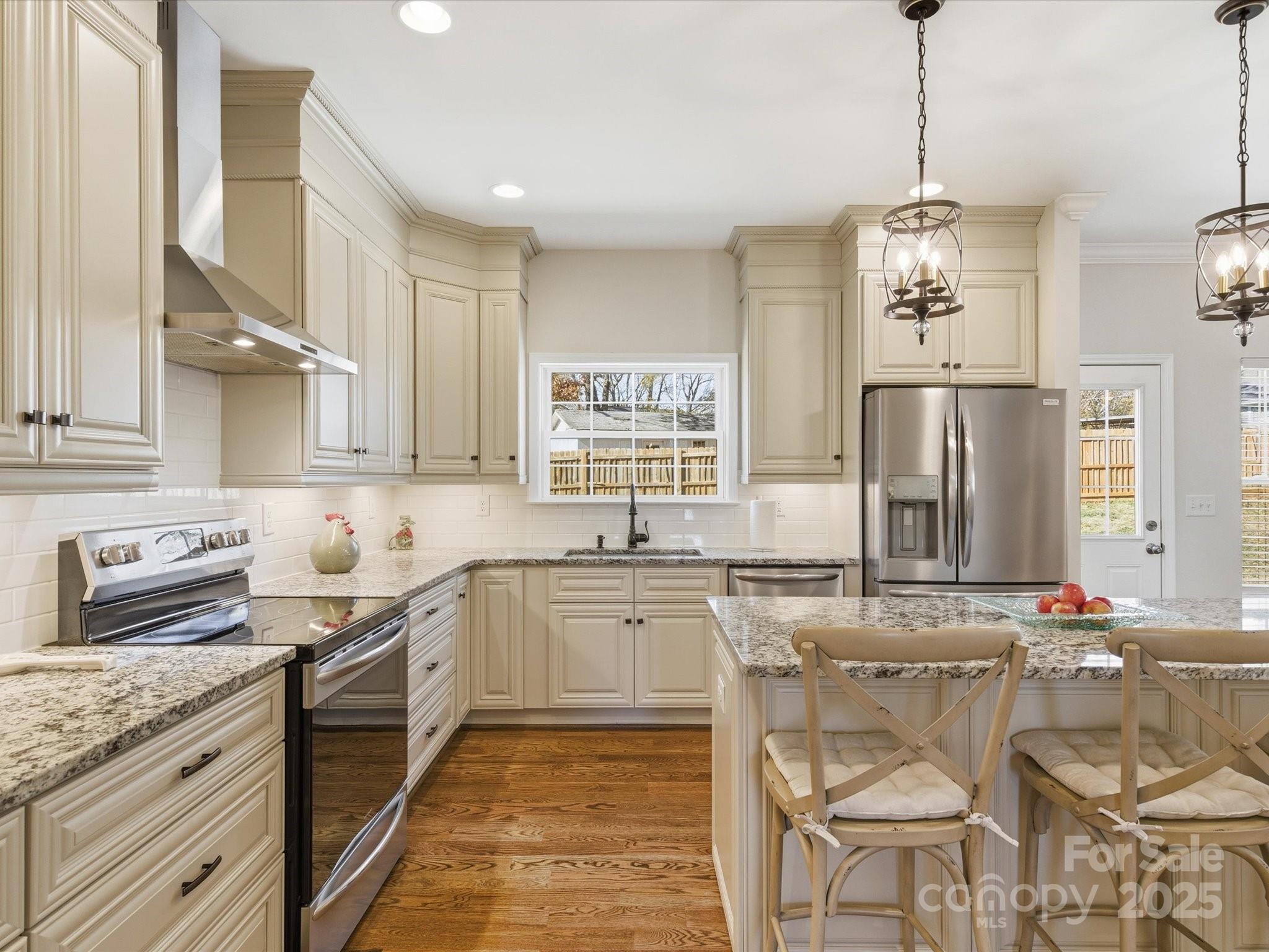 3211 Oakdale Road Charlotte, NC 28216 - Photo 11 of 43 a kitchen with stainless steel appliances granite countertop a sink stove and refrigerator
