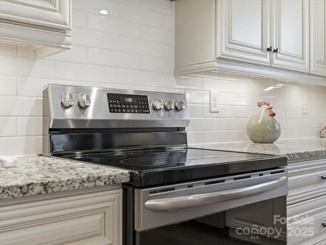 a stove top oven sitting inside of a kitchen