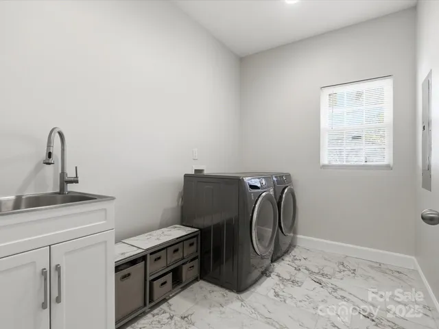 a view of a storage and utility room with a sink