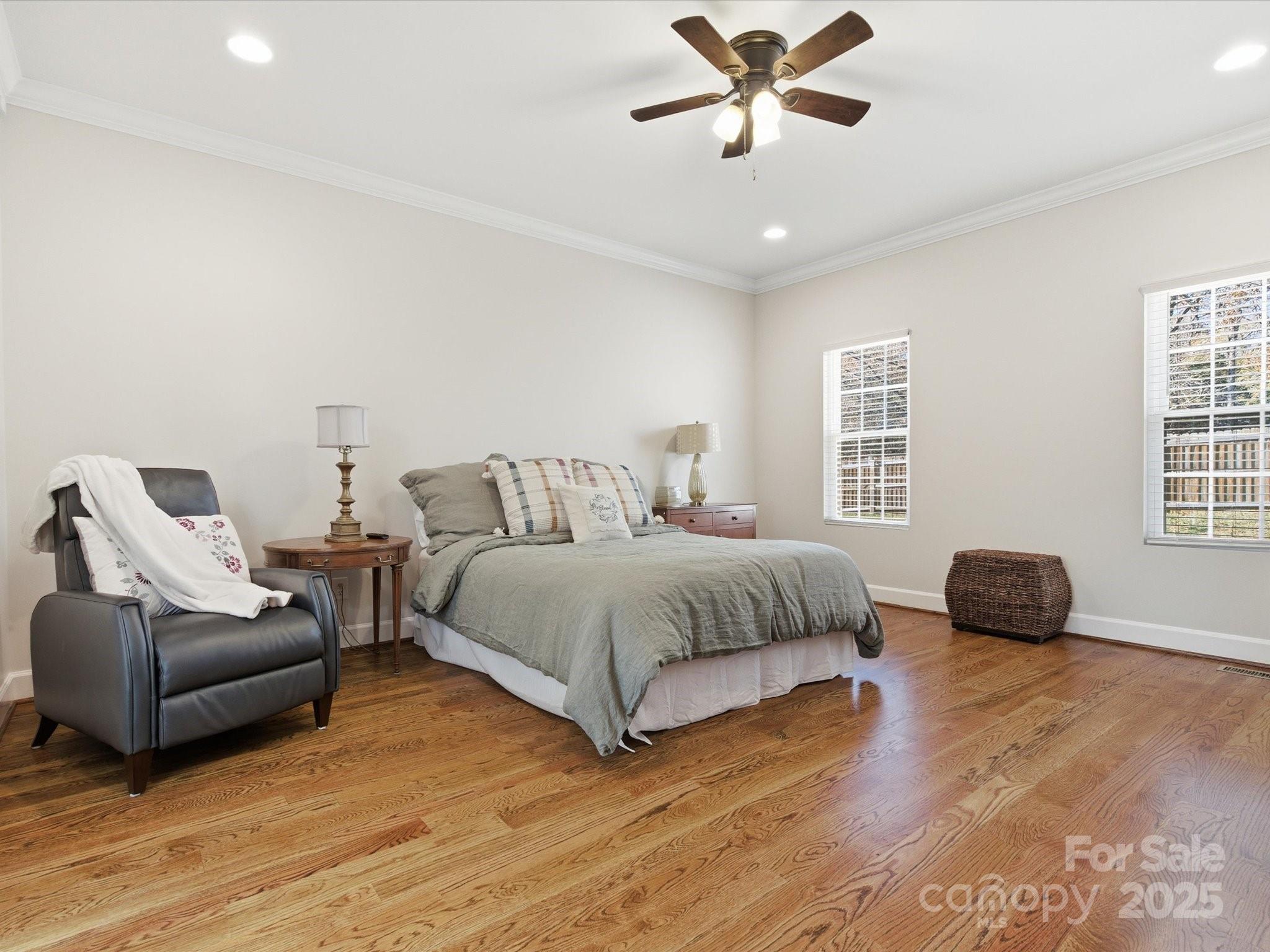 3211 Oakdale Road Charlotte, NC 28216 - Photo 19 of 43 a bedroom with a bed and wooden floor