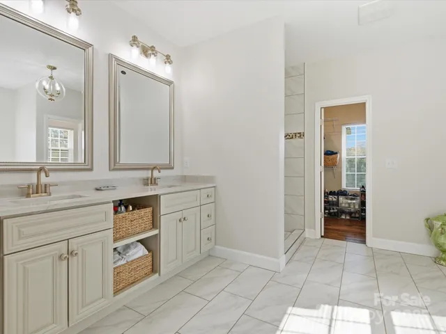 a spacious bathroom with a granite countertop sink and a mirror