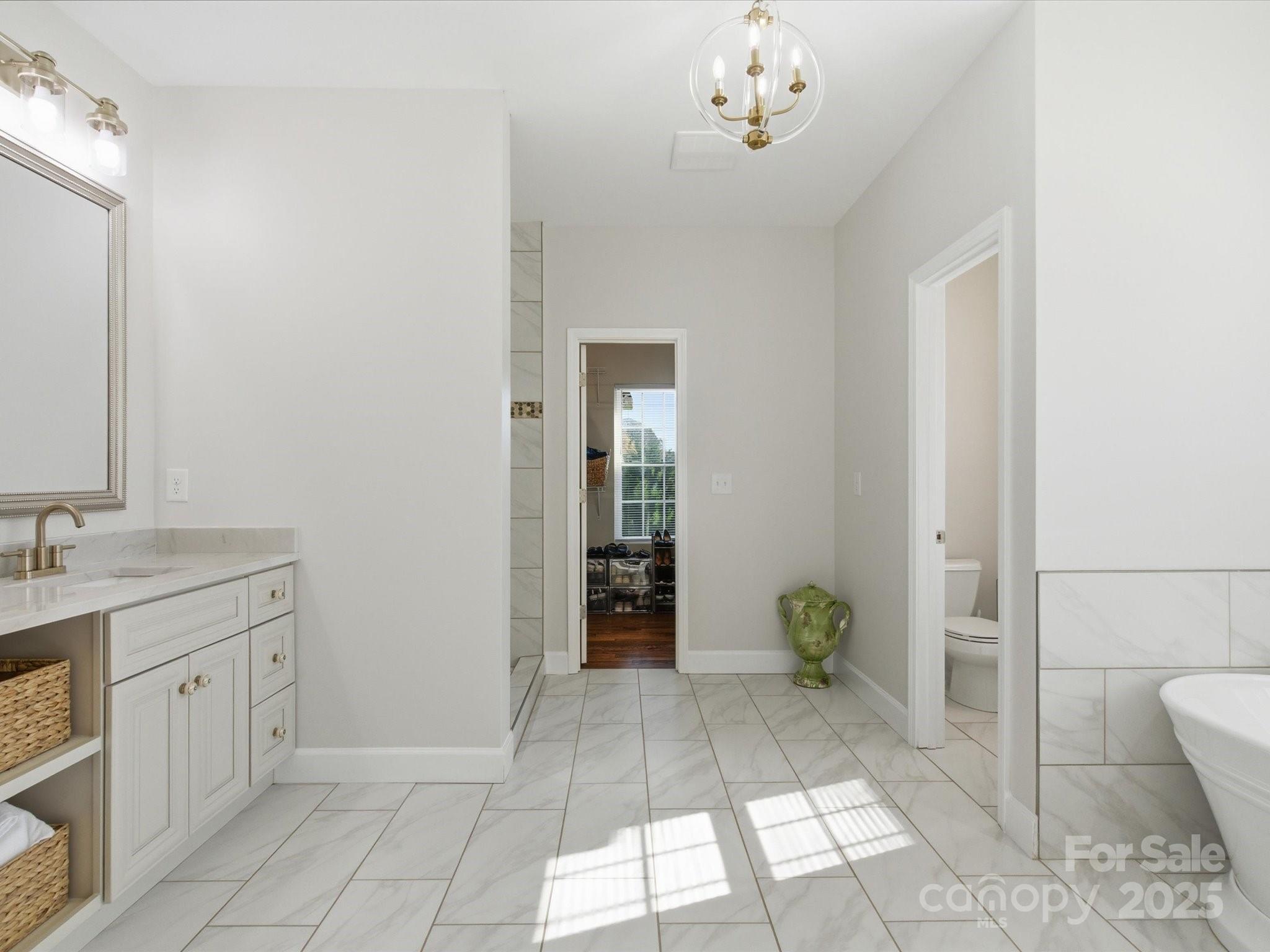 3211 Oakdale Road Charlotte, NC 28216 - Photo 23 of 43 a bathroom with a sink a toilet and a mirror