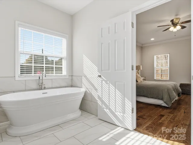 a spacious bathroom with a bathtub and next to a window