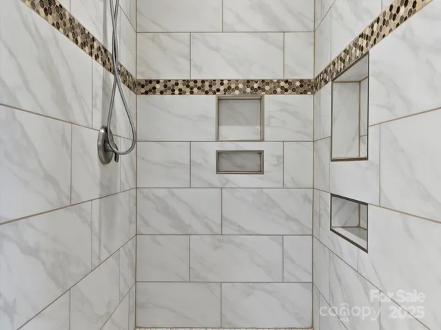 a bathroom with a window and a shower