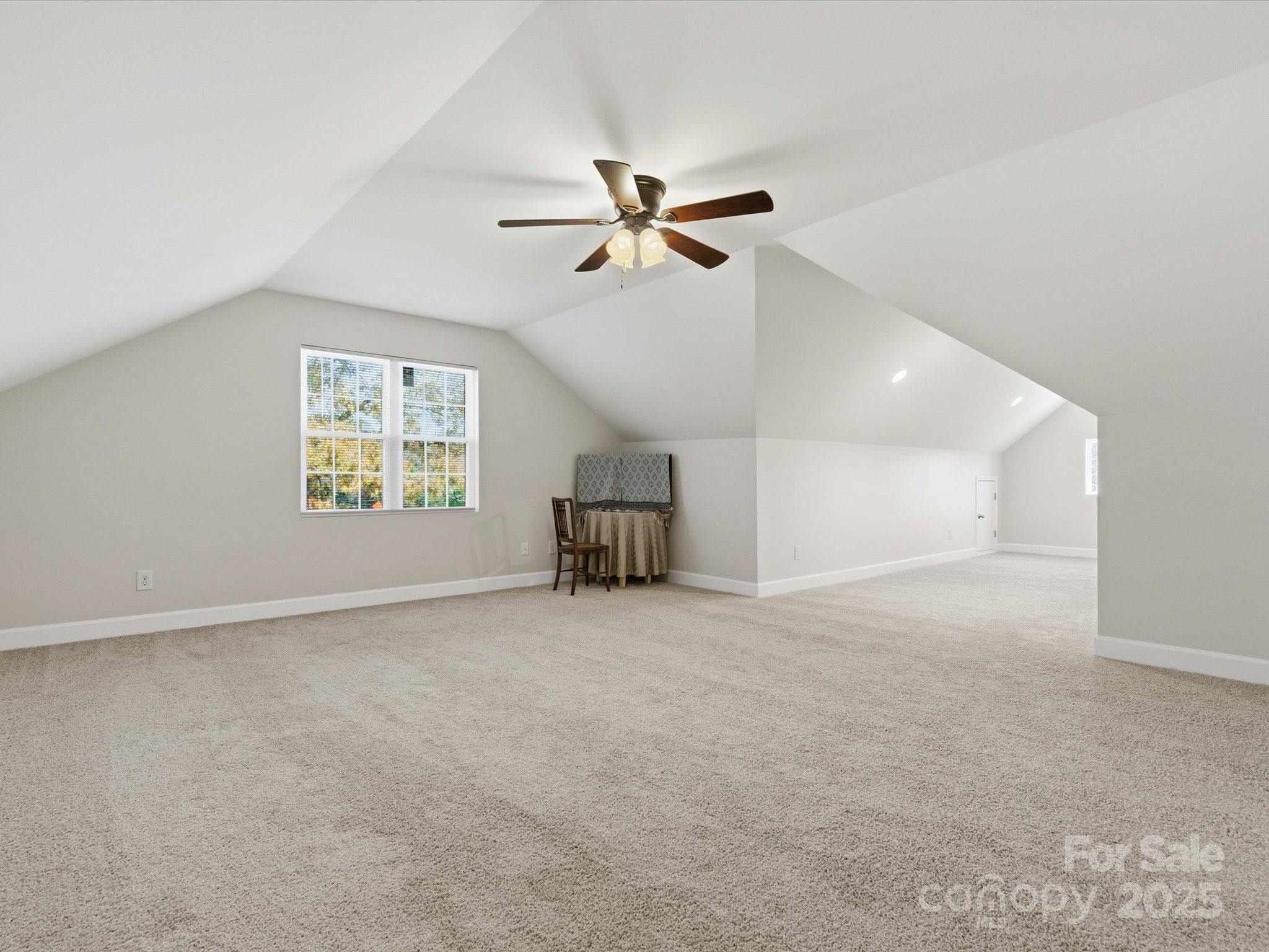 3211 Oakdale Road Charlotte, NC 28216 - Photo 31 of 43 an empty room with ceiling fan and windows