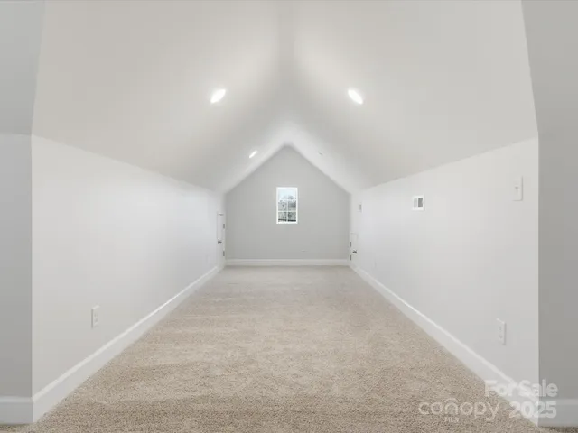 an empty room with a window and a ceiling fan