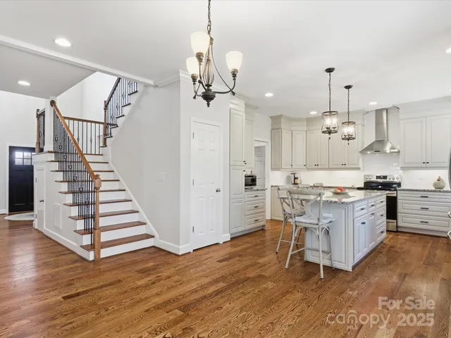 a open kitchen with white cabinets and stainless steel appliances
