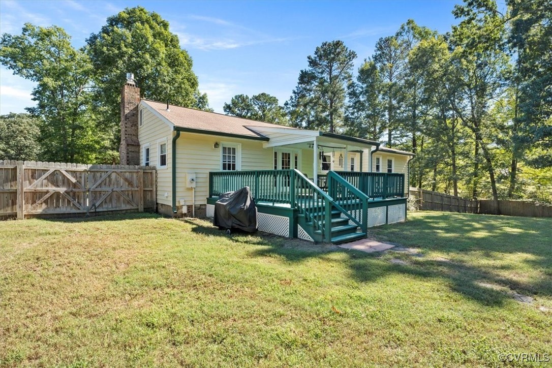 10459 Rockingham Road Mechanicsville, VA 23116 - Photo 37 of 48 Rear view of house featuring a deck and a yard