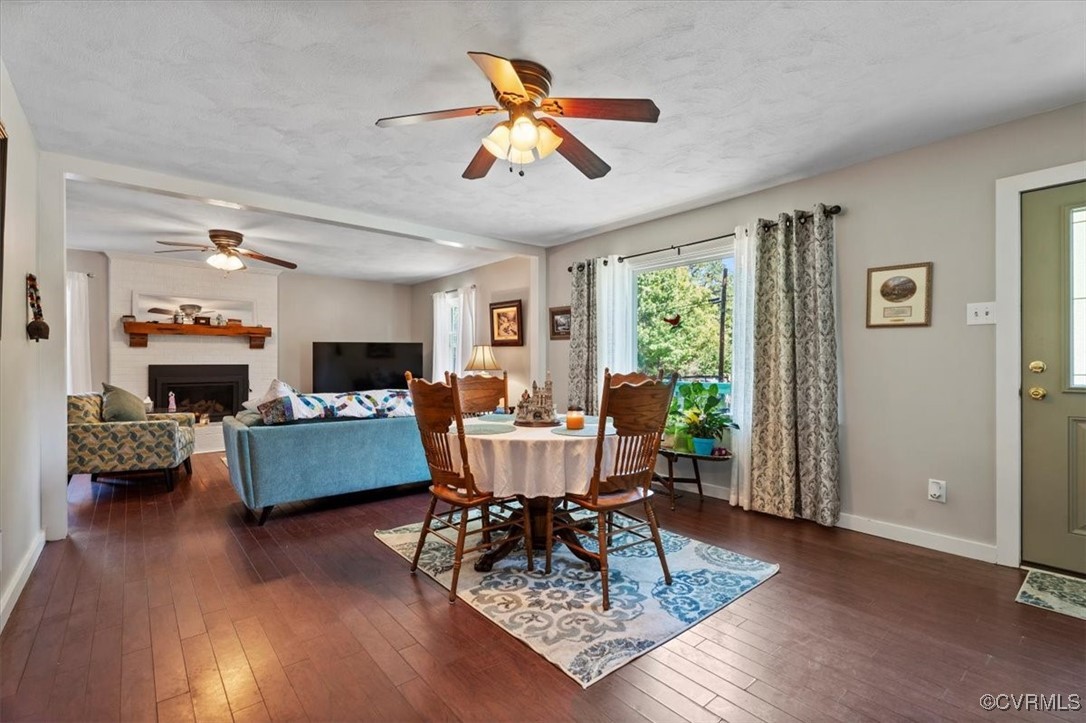 10459 Rockingham Road Mechanicsville, VA 23116 - Photo 10 of 48 Dining area with a textured ceiling, a fireplace,