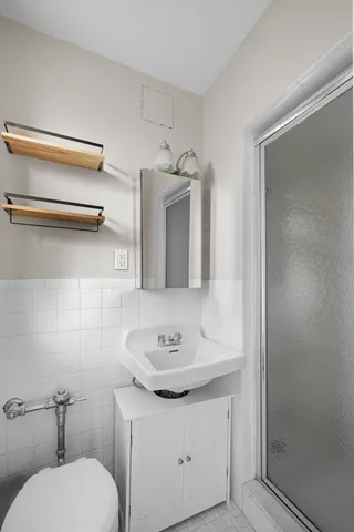 a bathroom with a tub sink vanity and mirror