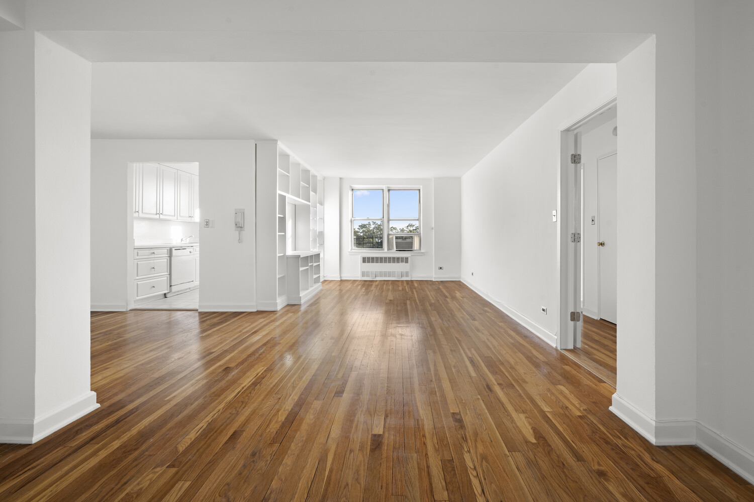 wooden floor in an empty room with a window