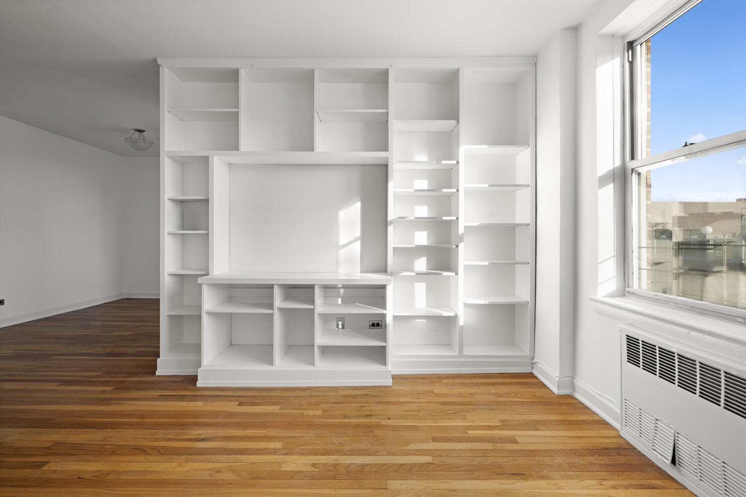 3512 Oxford Avenue, Unit 6C Bronx, NY 10463 - Photo 5 of 12 a view of empty room with wooden floor and windows