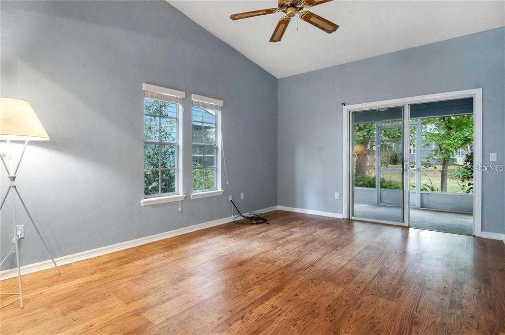 431 Northwest 50th Boulevard, Unit K Gainesville, FL 32607 - Photo 4 of 11 a view of an empty room with a window and wooden floor