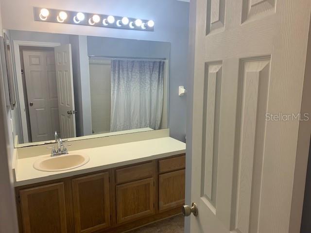 431 Northwest 50th Boulevard, Unit K Gainesville, FL 32607 - Photo 8 of 11 a bathroom with a sink vanity and a mirror