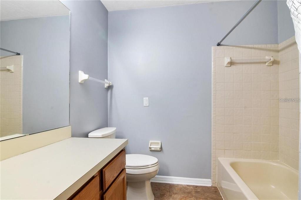 431 Northwest 50th Boulevard, Unit K Gainesville, FL 32607 - Photo 10 of 11 a bathroom with a sink a toilet and shower