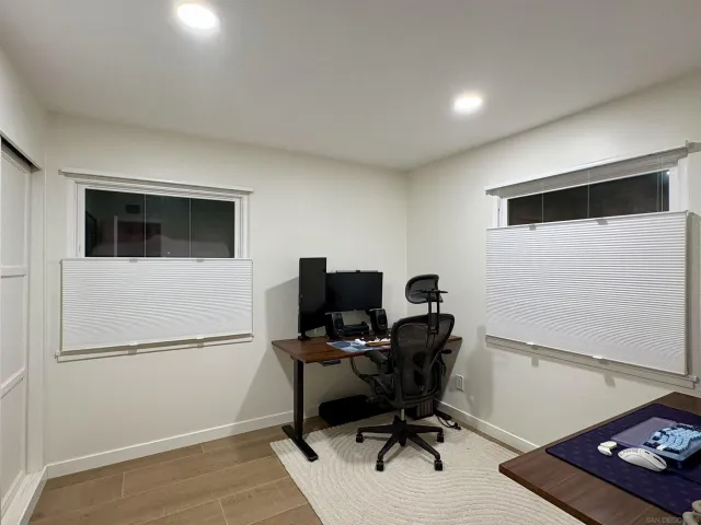 a view of workspace with wooden floor windows