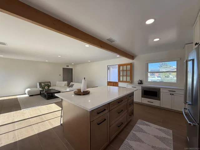 a kitchen with sink stove and cabinets