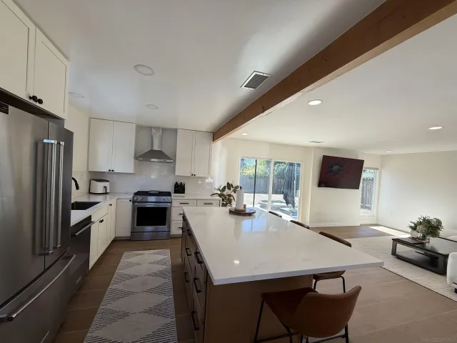a kitchen with sink stove and refrigerator