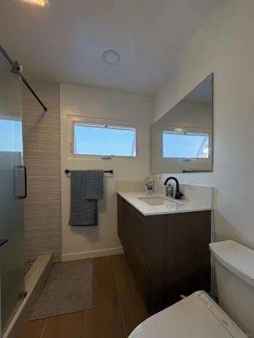 a bathroom with a sink toilet and mirror