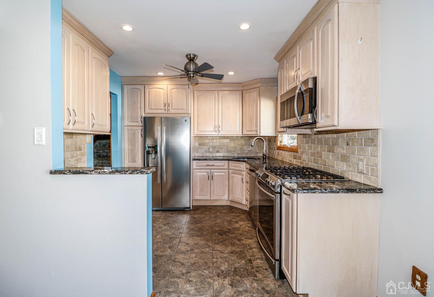 22 Hill Road Edison, NJ 08817 - Photo 16 of 38 a kitchen with stainless steel appliances granite countertop a refrigerator a stove and a sink