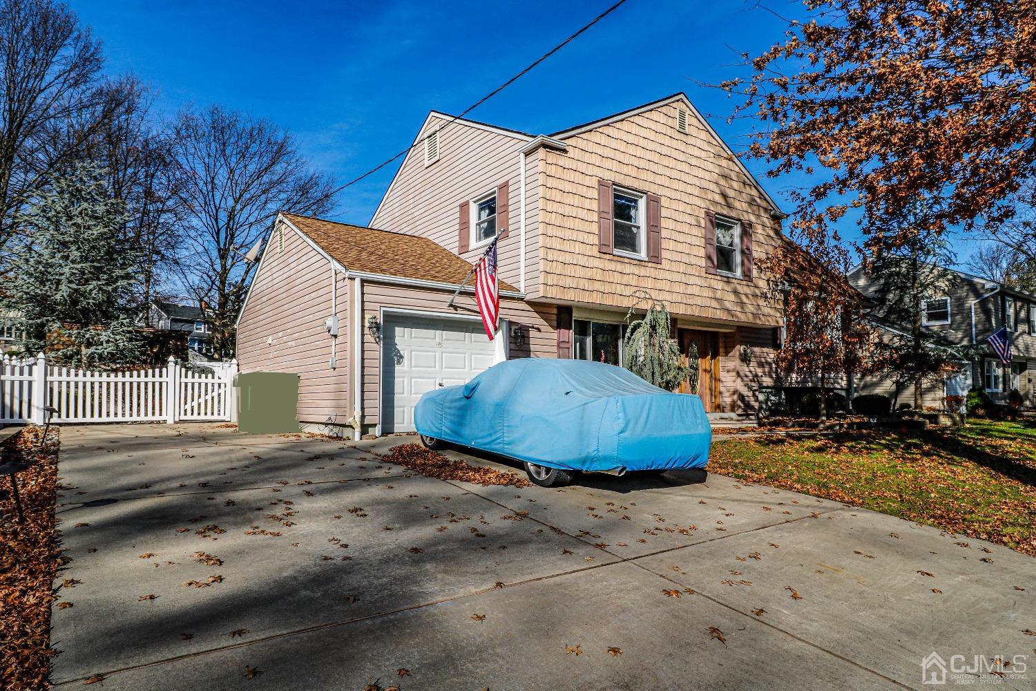 22 Hill Road Edison, NJ 08817 - Photo 2 of 38 a view of a white house with a yard and large tree