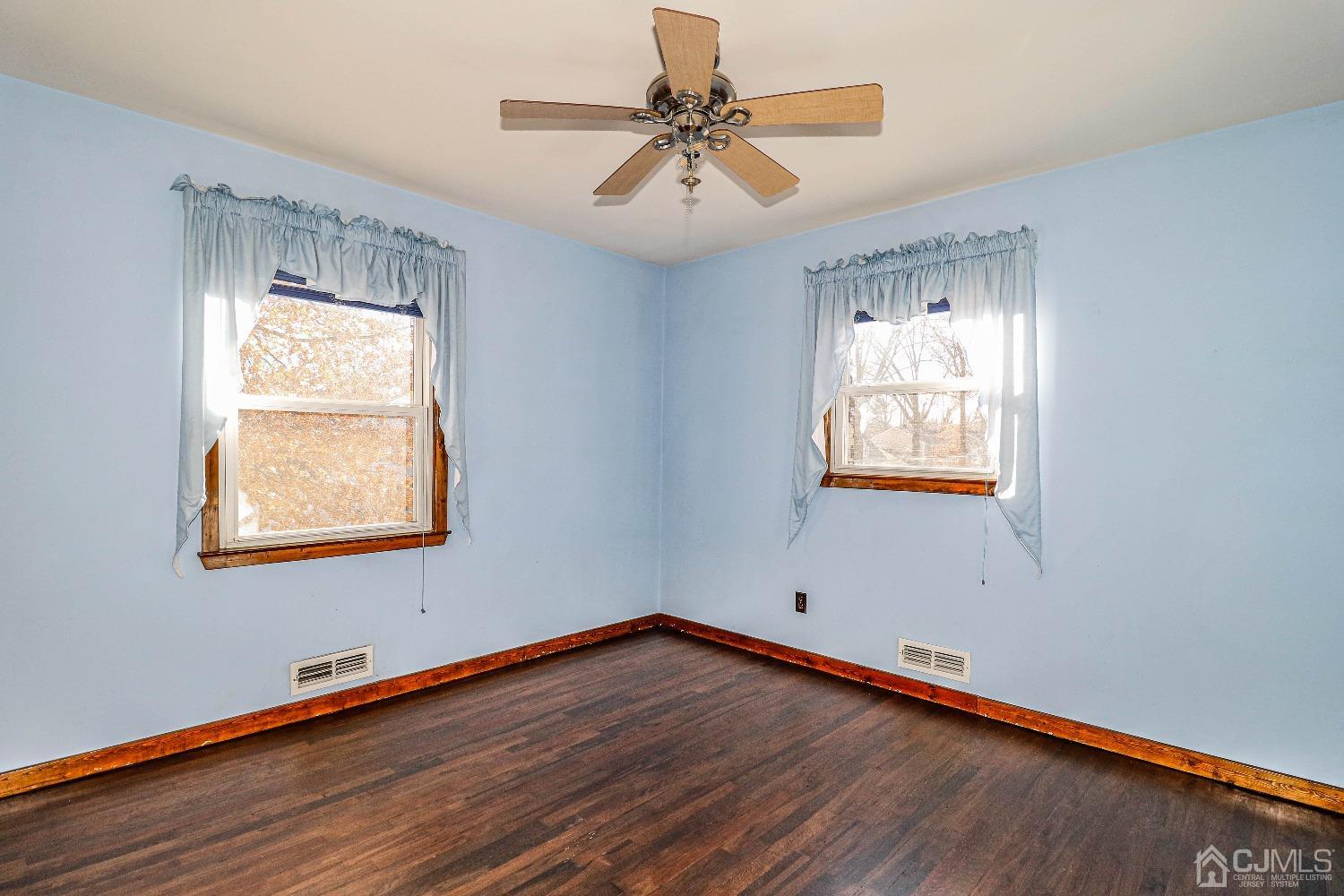 22 Hill Road Edison, NJ 08817 - Photo 23 of 38 a view of an empty room with window and wooden floor