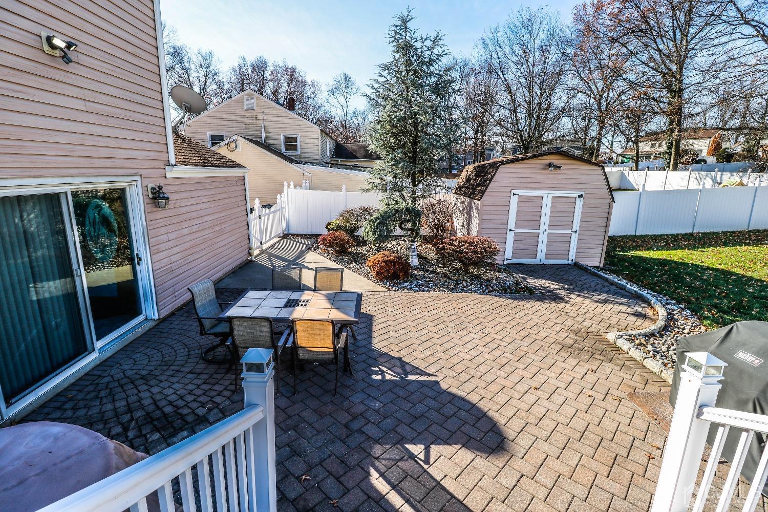 22 Hill Road Edison, NJ 08817 - Photo 36 of 38 a view of a chairs and table in backyard of the house