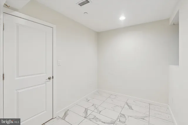 an empty room with white walls