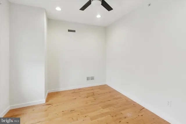 a view of hallway with wooden floor