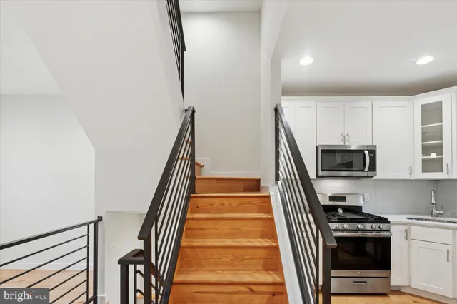 a view of a kitchen with wooden floor and electronic appliances