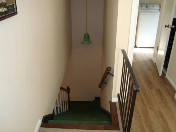 a view of staircase with wooden floor
