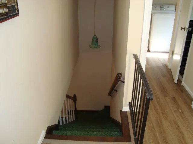 a view of staircase with wooden floor