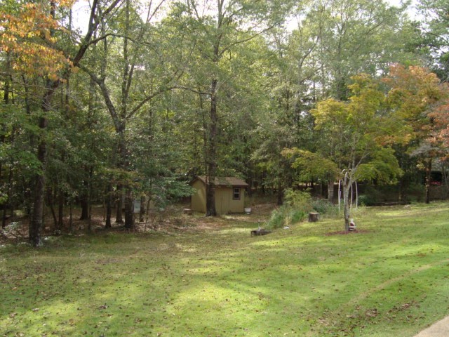 1400 Hubbard Road Columbus, GA 31904 - Photo 9 of 31 a backyard of a house with lots of green space and fountain