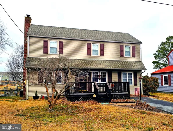a front view of a house with street yard and sitting area