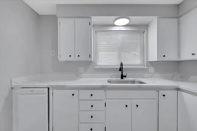 a kitchen with white cabinets
