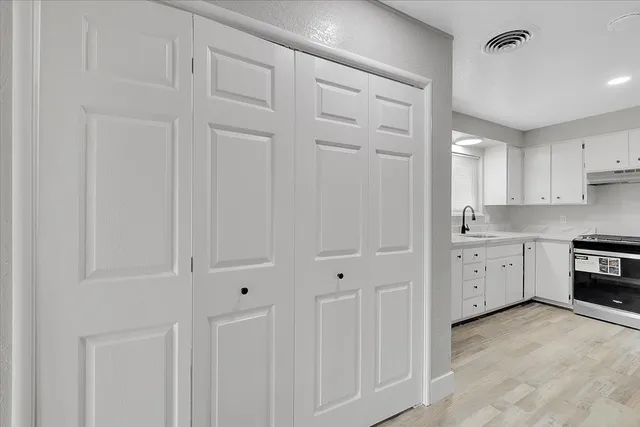 a large white kitchen with white cabinets