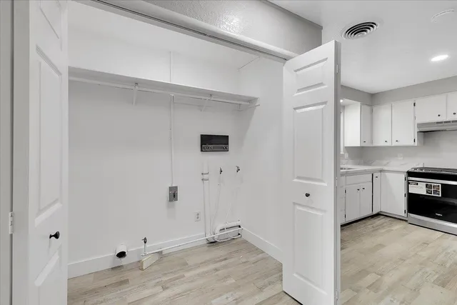 a view of a kitchen with electric appliances