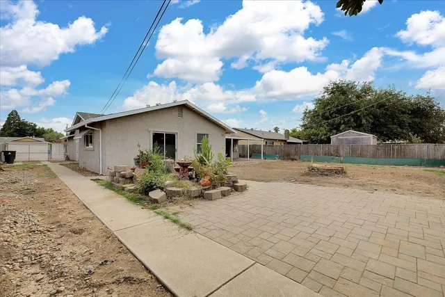 a view of backyard with plants and outdoor seating