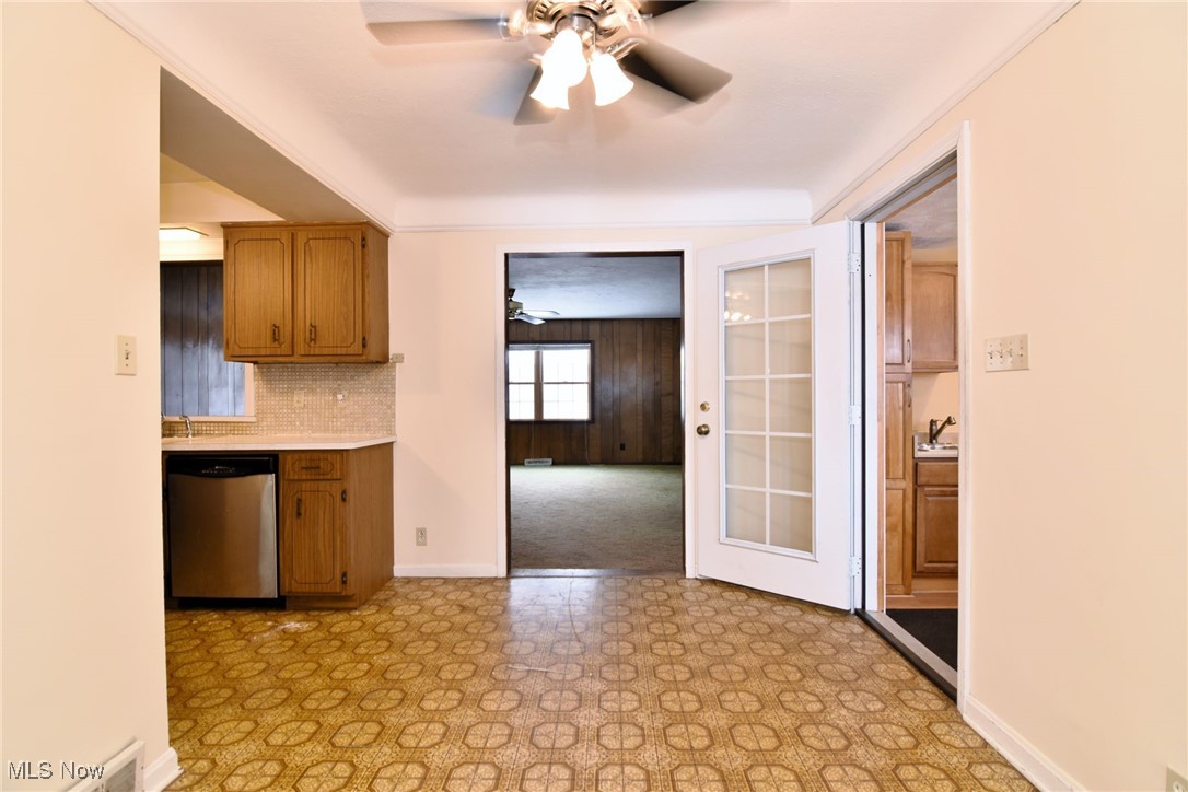 6308 Highland Road Cleveland, OH 44143 - Photo 11 of 40 Kitchen with ceiling fan, light countertops, decorative backsplash, dishwasher, and light floors