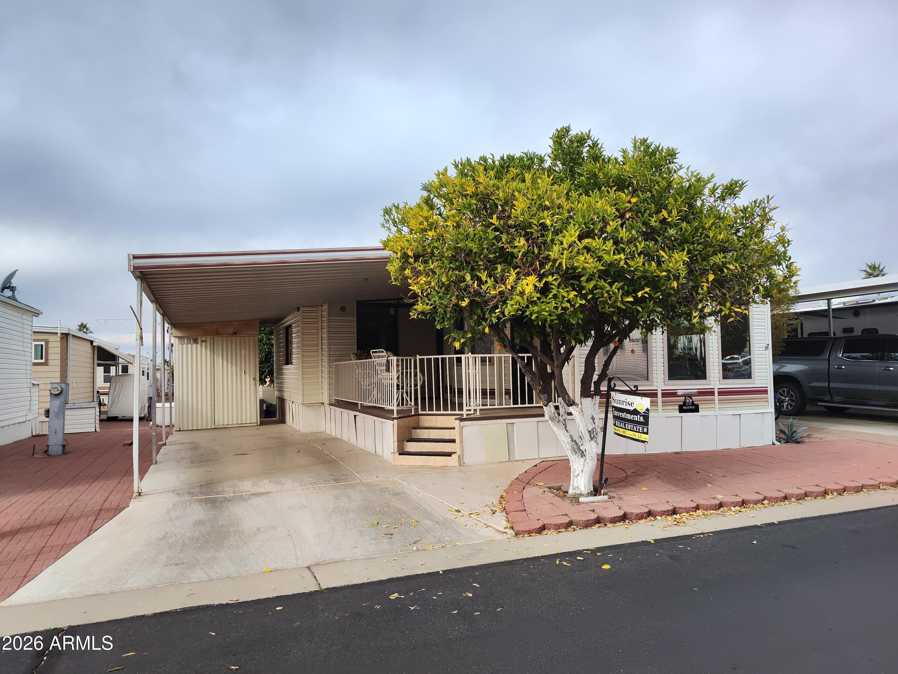 7750 East Broadway Road, Unit LOT 212 Mesa, AZ 85208 - Photo 11 of 12 a outdoor space with a large tree
