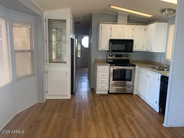 a kitchen with stainless steel appliances a stove a sink and a microwave