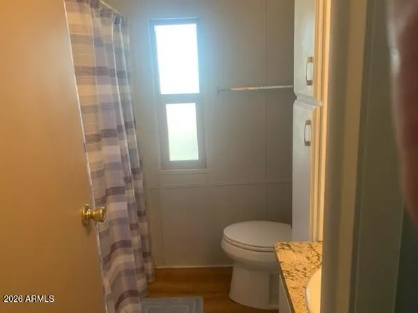 a bathroom with a toilet and a shower