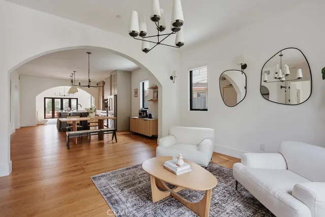 a living room with furniture a window and a chandelier