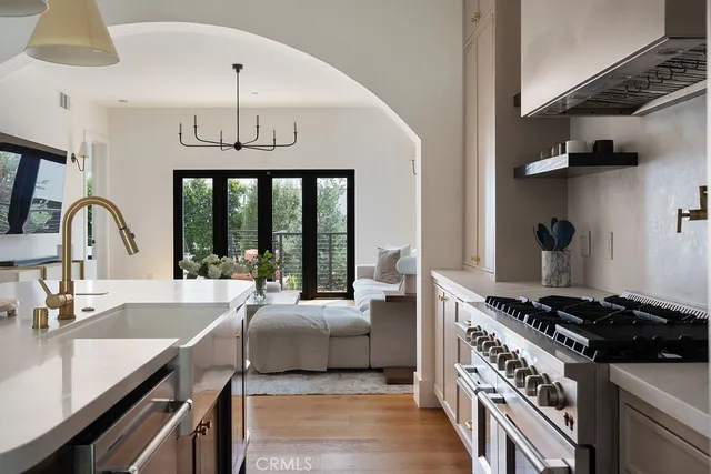 a kitchen with a sink a stove and cabinets